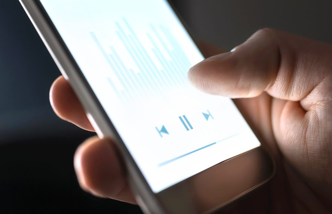 Listening to the Rehabbing Your Revenue Cycle podcast on a smartphone